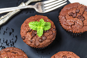 chocolate muffin with mint on a wooden table