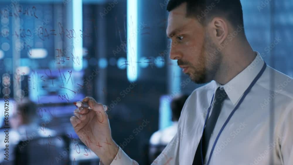 Aufkleber in system control center chief engineer writes with red marker on a glass board. in the background m