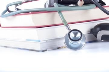 Concept of medical education with books, stethoscope and blood pressure cuff