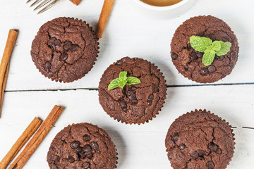 chocolate muffin with mint on a wooden table