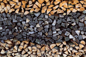 Abstract photo of pile of natural wooden background, wall firewood, wood texture.