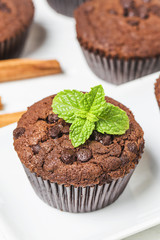 chocolate muffin with mint on a wooden table