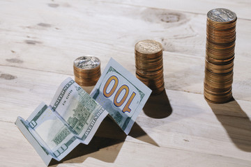 A conceptual shot of us dollar bill folded as to show an upward trend, growth in a business.
