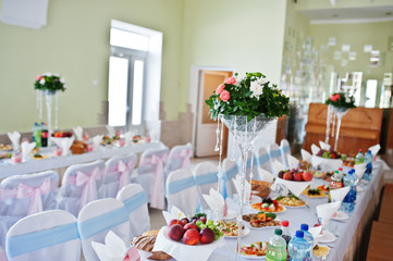 Vase with flowers at wedding tables set.