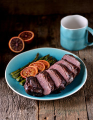 Duck breast baked in orange-honey sauce with asparagus. Rustic style.