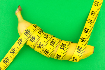 a banana and a centimeter on a green background