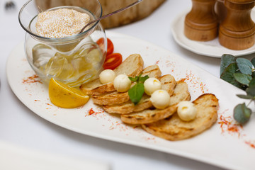 Delicious bruschetta with tomatoes on plate on table close-up Buffet table white plates