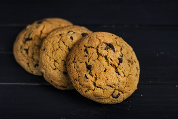 Peanut butter cookies with chocolate chips on black table