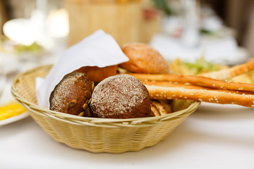 Bread in basket with butter under sunlight Buns bread in a basket table