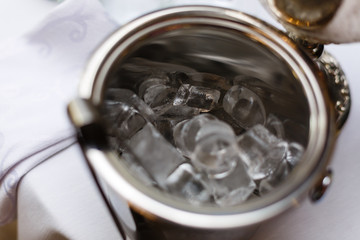 green plastic bucket with ice cubes