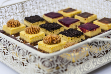 Mini cheesecakes mix on a vintage tray