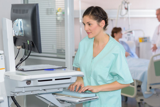 nurse looking at x-rays on a computer screen