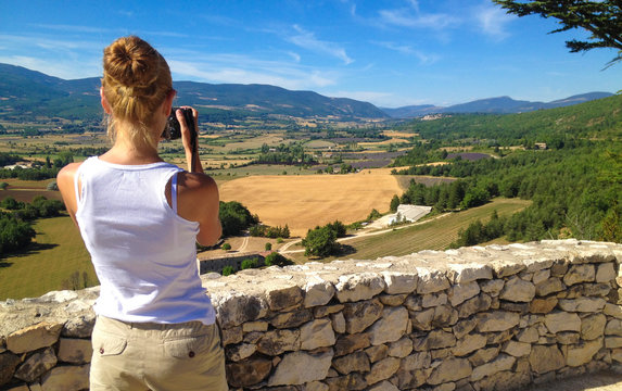 Girl takes pictures of the landscape of Provence