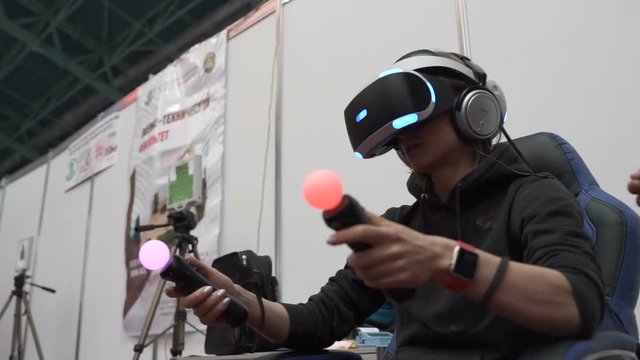 emotional girl playing a virtual reality headset