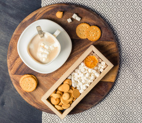 Cup of Cocoa with marshmallows, cookies in wooden box. Dark wooden background.