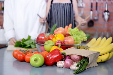 Colorful vegetables and fruits on little chef background in the kitchen