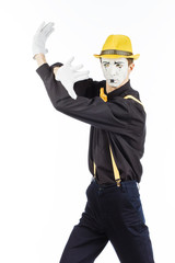 Portrait of a man, artist,clown, MIME. Shows the stop sign is forbidden.