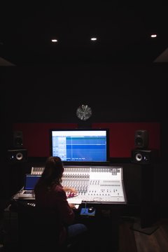 Male audio engineer using sound mixer