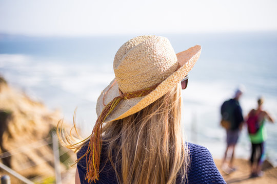 Young, blonde female, girl in a straw hat on the sun. California. Spring. Pacific ocean. California