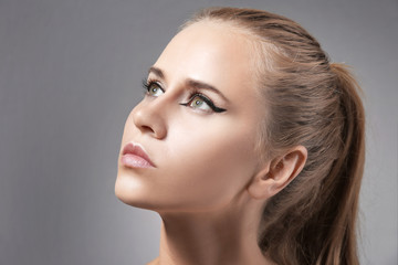 Naklejka premium Beautiful young girl face on color background