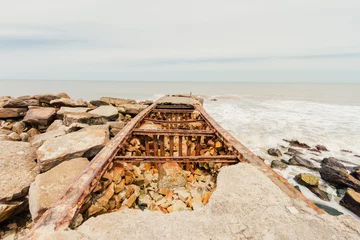 Papier Peint photo Jetée Old broken and abandoned pier on the coast of Mar del Plata, Argentina
