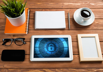 Web security and technology concept with tablet pc on wooden table