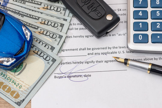 documant, dollar, pen, calculator and toy car with keys.