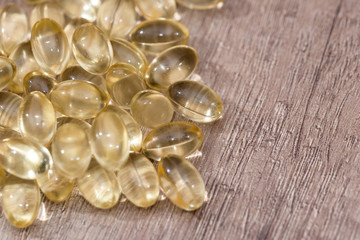 many cod liver oil omega 3 capsules on desk
