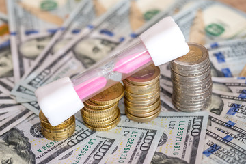 euro coin with hourglass and dollar. business concept