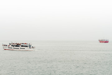 A tourist excursion boat with fishing boat in the background on the Atlantic sea in Mar del Plata