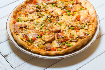 Homemade pizza on a wooden background