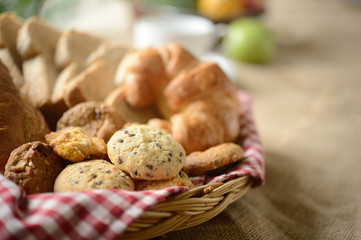 Freshly baked chocolate chip cookies with bread in basket