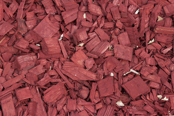 Red wood chips texture, wooden decorative background.