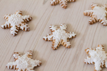 Fototapeta na wymiar Gingerbread snowflake on wood background. 