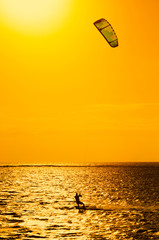 Professional kiter makes the difficult trick on a beautiful background of sunset, Mauritius