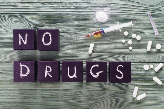 Design For International Day Against Drug Abuse. The Concept Of No Drugs Or Anti Doping In Sport Or Zero Tolerance To Drugs. No Drugs Concept, Drugs, Pills On A Wooden Background, Top View, Flat Lay.