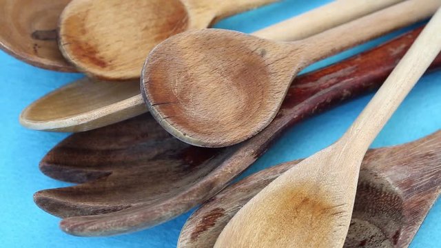 closeup of wooden cooking spoons on blue rotating table