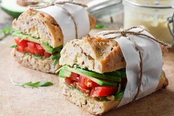 Wandaufkleber Vegan sandwich with avocado and tomatoes © yuliiaholovchenko