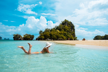 woman in straw hat resting tropical Thailand beach