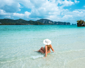 Fototapeta na wymiar woman in straw hat resting tropical Thailand beach