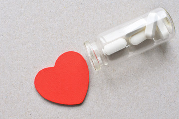 bottle with pills and red heart