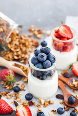 Delicious plain yogurt with fresh blueberry and strawberry in a glass jars