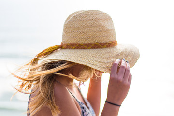 Young, blonde female, girl in a straw hat on the sun. California. Spring. Pacific ocean. California	
