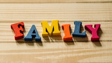 The word family out of colored wooden letters on the table.