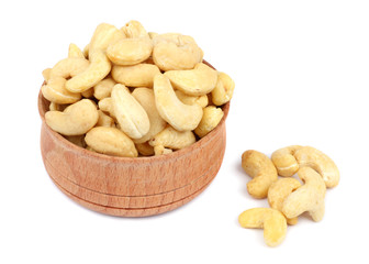 cashew in wood plate isolated on white background