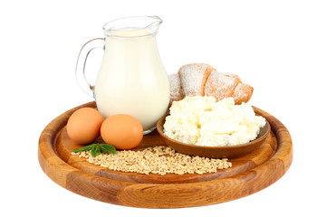 Glass jug pitcher of fresh milk with glass, eggs and cottage cheese isolated on white background...
