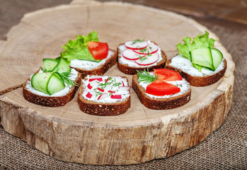 Assorted canapes with vegetables and salad. The concept of food and vegetarianism.