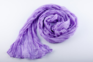 Elegant purple wrinkled chiffon scarf lay on white background