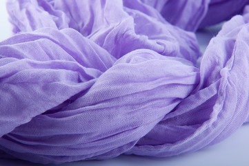 Close up of soft purple semitransparent wrinkled fabric on white background