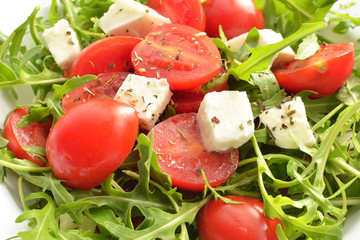 salad with tomatoes, fresh arugula and mozzarella